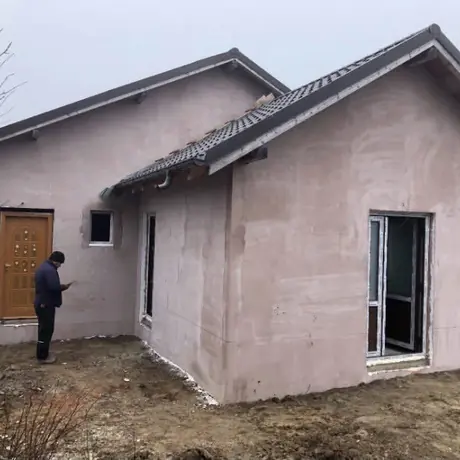 Casă la gri, cu tencuiala exterioară aplicată